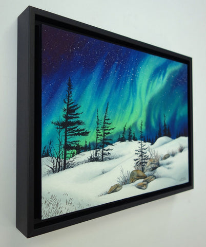 Dancing With the Stars by Karen Richardson.
Framed painting of Aurora borealis over a snowy landscape with trees and rocks.