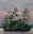 A watercolor painting of a small island with tall green pine trees under a soft pink, purple, and blue sky, with calm water in the foreground. Titled Evening Magic by Karen Richardson