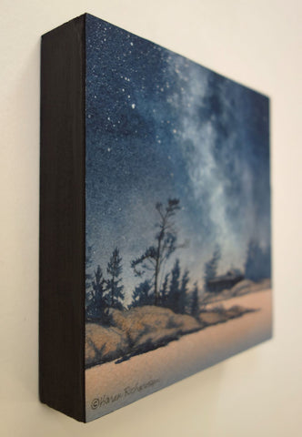 Painting of a starry night sky over a silhouette of trees and a cabin, titled Finding Peace, by Karen Richardson.