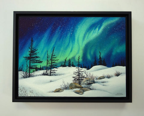 Dancing With the Stars by Karen Richardson.
Framed painting of Aurora borealis over a snowy landscape with trees and rocks.